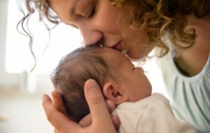 Mother kissing newborn baby boy (0-1 months) --- Image by © Buero Monaco/Corbis