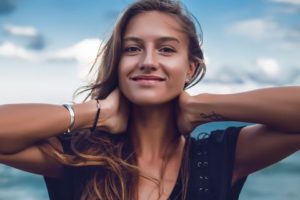 portrait-of-happy-young-woman-on-beach-head-and-royalty-free-image-926877000-1534528089